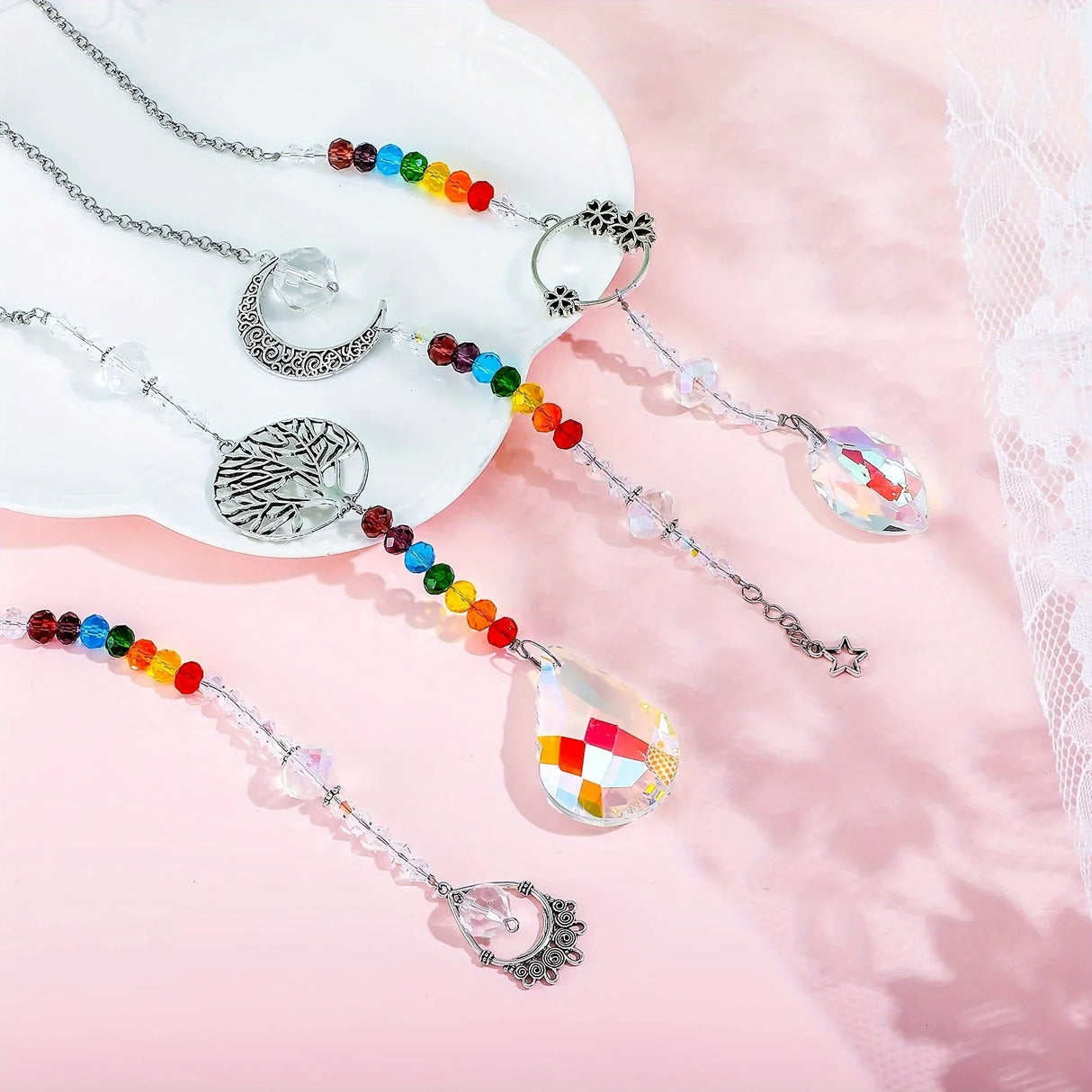 Decorative car hangers with colorful beads and silver charms on a pink background