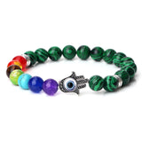 Colorful beaded bracelet with a Hamsa hand charm on a white background