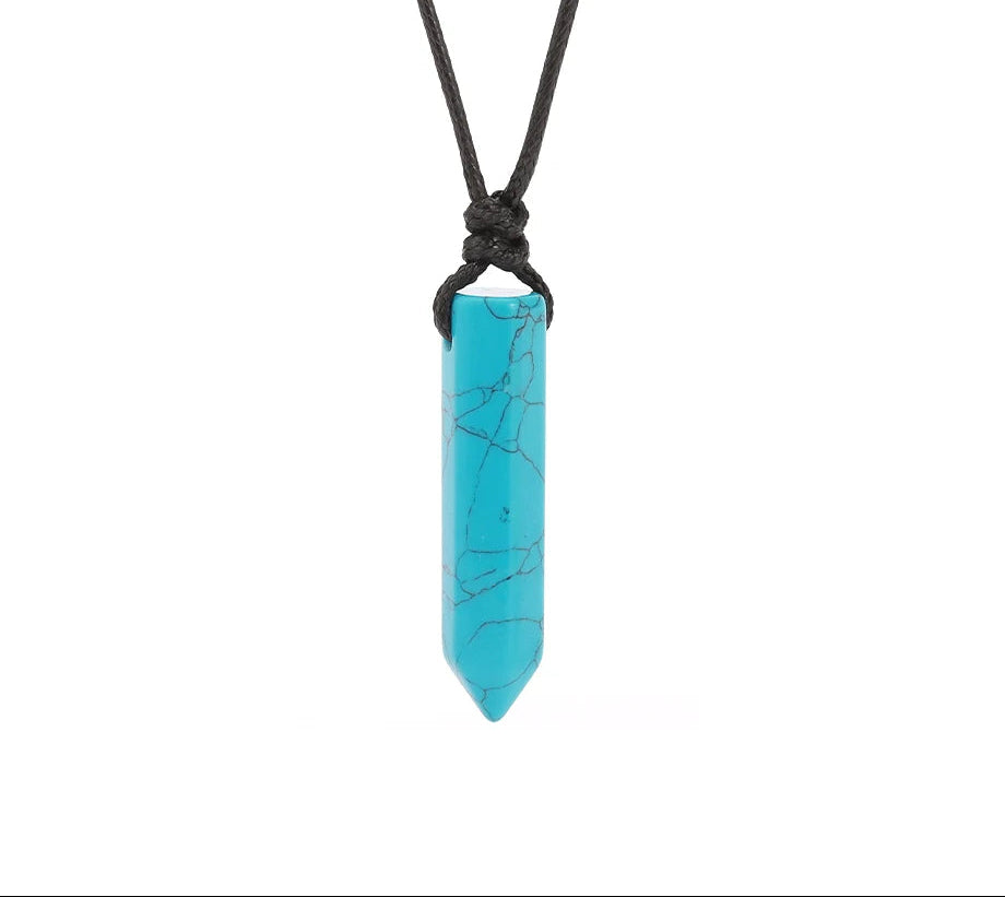 Turquoise crystal pendant on a black cord against a white background