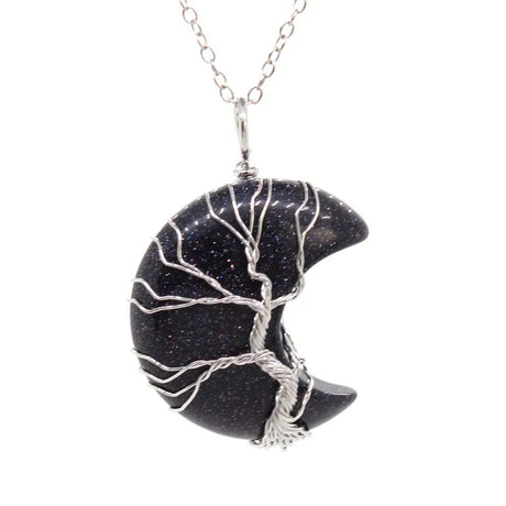 Black stone pendant with silver tree design on a white background