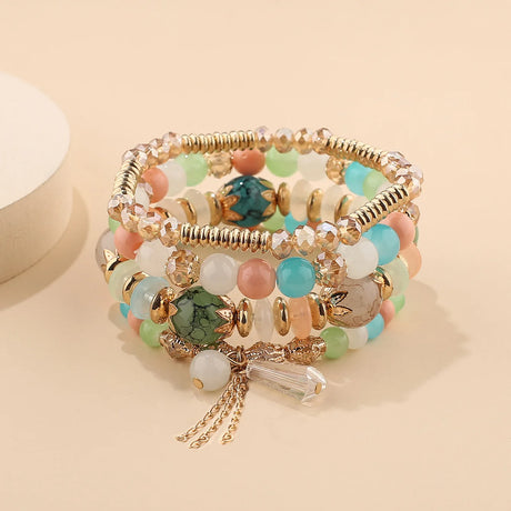 Multicolored beaded bracelet with gold accents on a beige background
