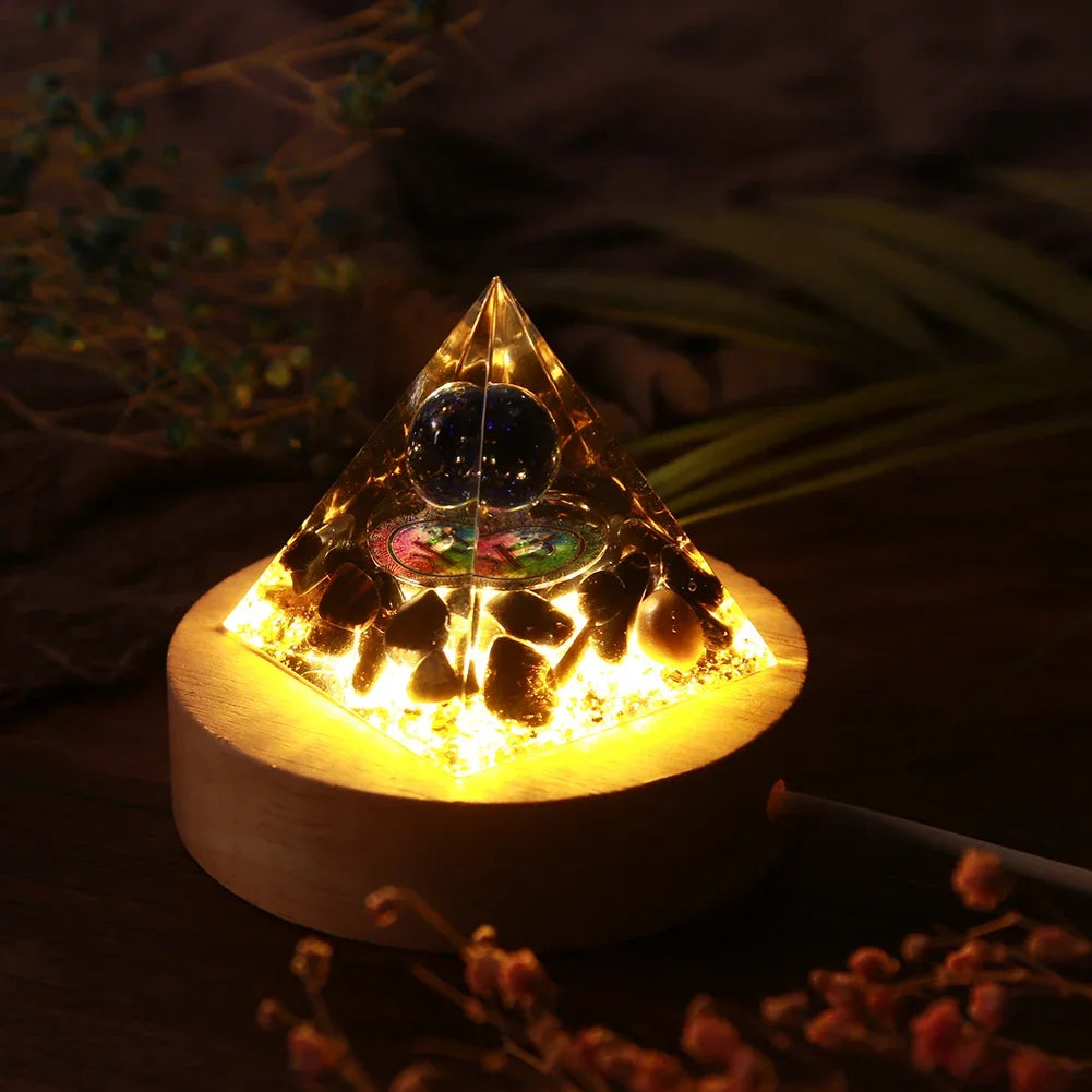 Pyramid-shaped light fixture with glowing base on a dark background