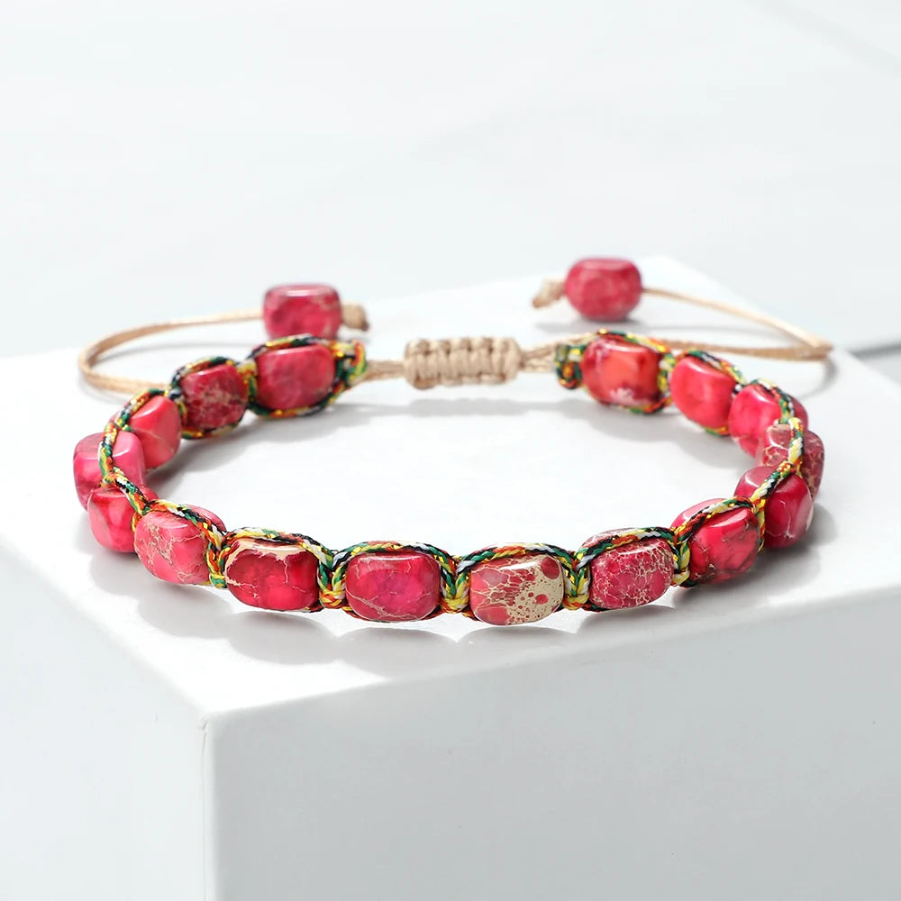 Beaded bracelet with pink and gold accents on a white background