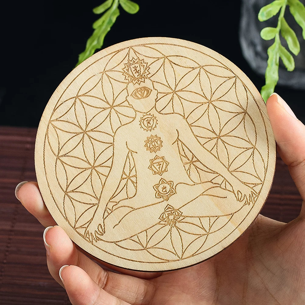 Round wooden coaster with laser-cut design of a woman and floral patterns held by a hand.