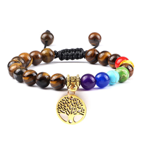 Multicolored beaded bracelet with a gold tree of life charm on a white background