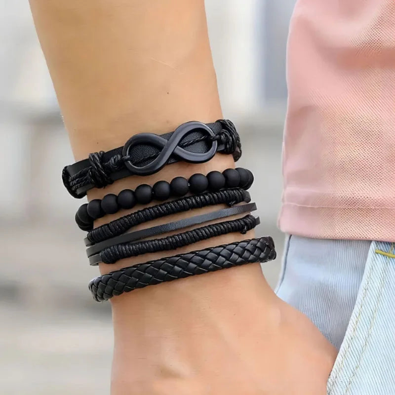 Collection of black bracelets on a wrist with a blurred background
