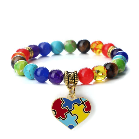 Colorful beaded bracelet with a heart-shaped puzzle piece charm on a white background