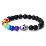 Multicolored beaded bracelet with a Hamsa hand charm on a white background