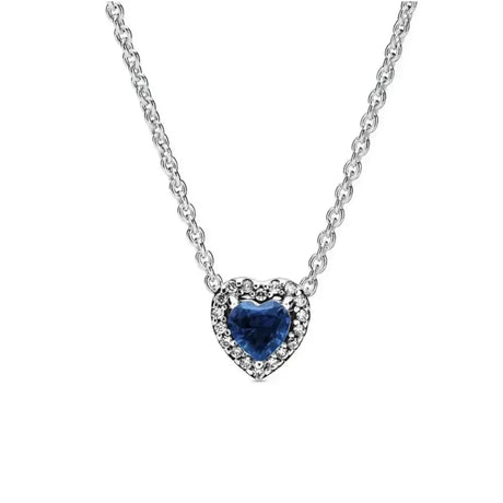 Heart-shaped necklace with a blue gemstone on a white background