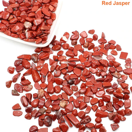 Red jasper stones with a white bowl on a white background