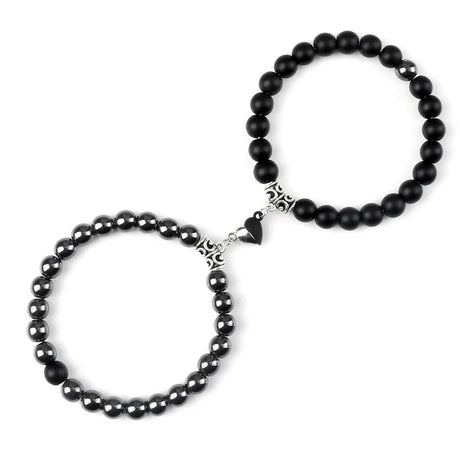 Two black beaded bracelets with silver clasp on a white background
