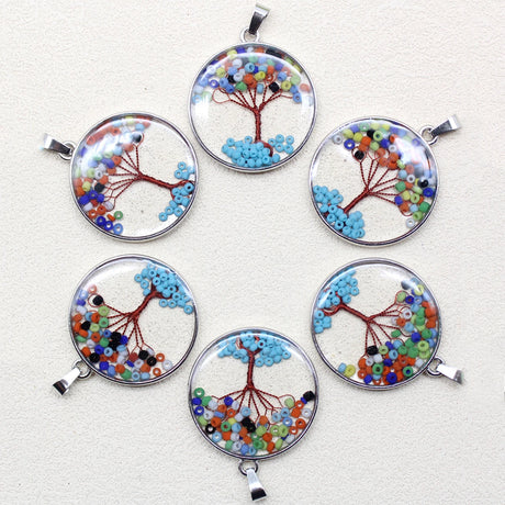Set of six circular bead tree pendants on a white background