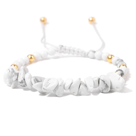 White beaded bracelet with gold accents on a white background