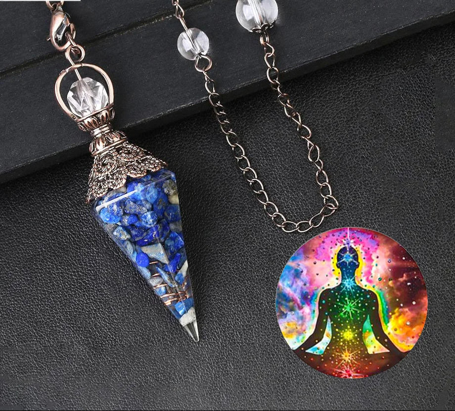 Two pendants on a dark surface, one blue and ornate, the other with a colorful meditating figure.