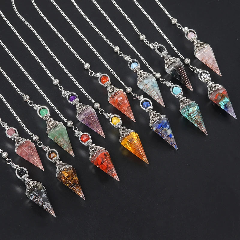 Colorful crystal pendants on silver chains against a dark background