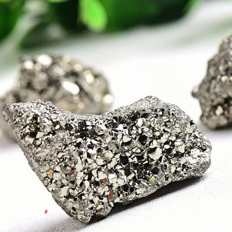 Close-up of a pyrite crystal with a blurred green background