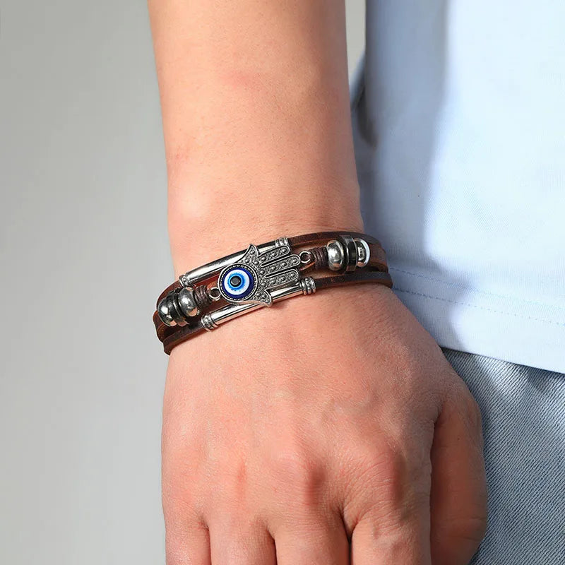 Bracelet with eye design worn on wrist against a neutral background