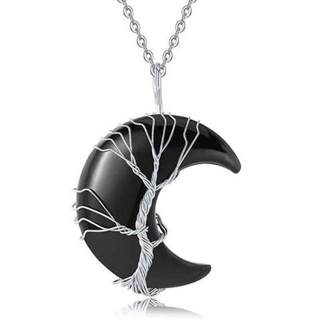 Black crescent moon pendant with silver tree design on a white background