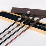 Set of magical wands with decorative handles in a box on a white background