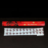 Red incense box with 'Rosa Vermelha' branding on a dark background