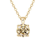 Gold necklace with a round diamond pendant on a white background