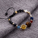 Multicolored beaded bracelet on a textured fabric background