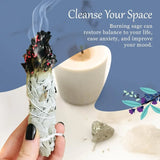 Sage bundle being burned with a candle and text about its benefits on a blue background