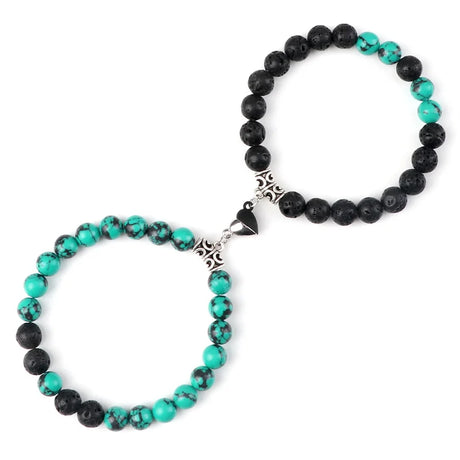 Pair of black and turquoise beaded bracelets with a silver clasp on a white background