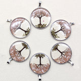 Set of six tree-themed pendants on a white background