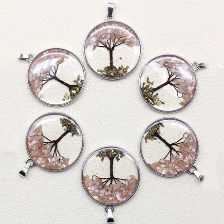 Set of six tree-themed pendants on a white background