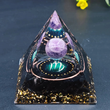 Crystal pyramid with a purple sphere and zodiac symbol on a dark background