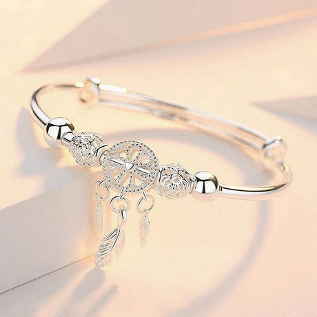 Silver bracelet with decorative elements on a light background