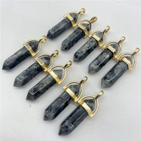 Set of black crystal pendants with gold accents on a white background