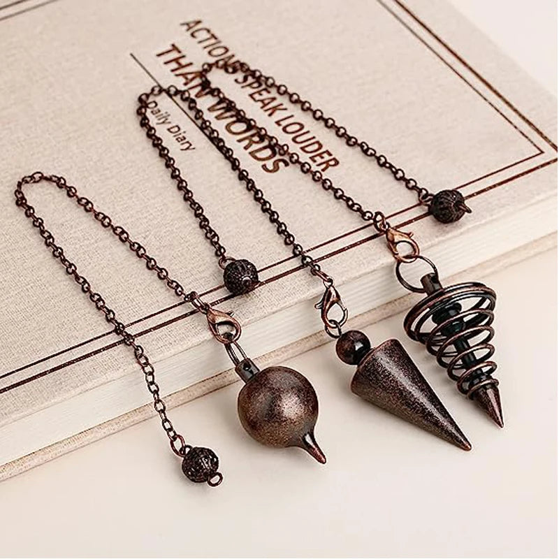 Three metallic pendulums on chains laid on a book