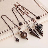 Three metallic pendulums on chains laid on a book