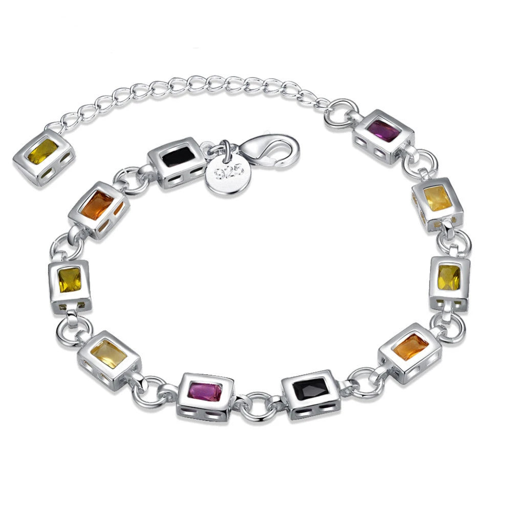Silver bracelet with colorful gemstones on a white background