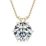 Gold necklace with a round diamond pendant on a white background