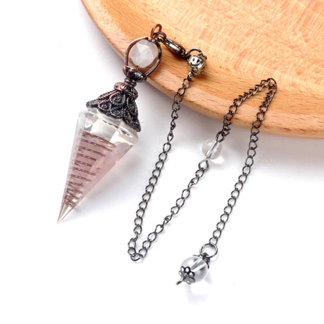 Crystal pendant necklace with chain on a wooden surface