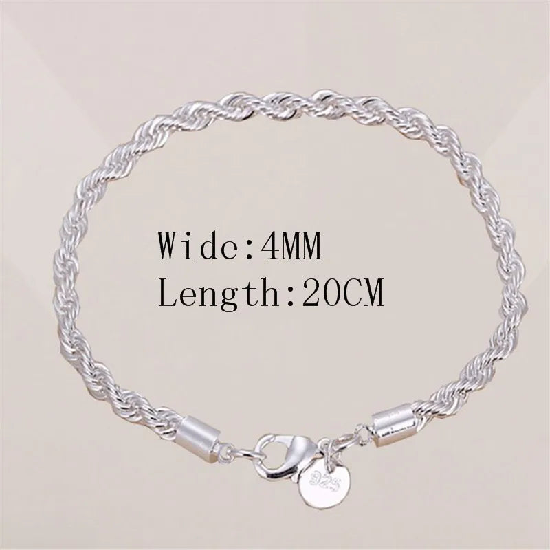 Silver bracelet with a clasp on a beige background