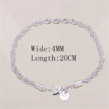 Silver bracelet with a clasp on a beige background
