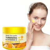 Woman applying turmeric and vitamin C face cream to her face with a jar of the cream next to her.