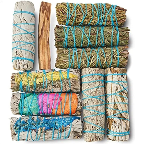 Collection of smudge sticks tied with blue string on a white background