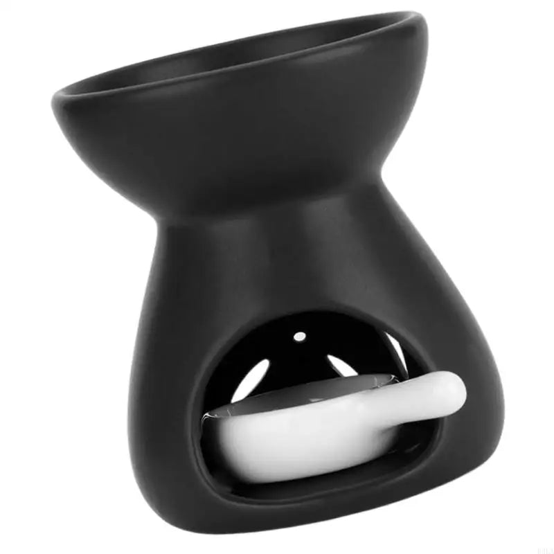 Black wax warmer with a white candle inside on a white background