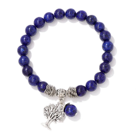 Blue beaded bracelet with silver tree of life charm on a white background