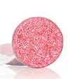 Pink bath bomb with sprinkles on a white background