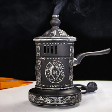 Decorative black and silver electric coffee grinder with steam rising from it on a dark background.