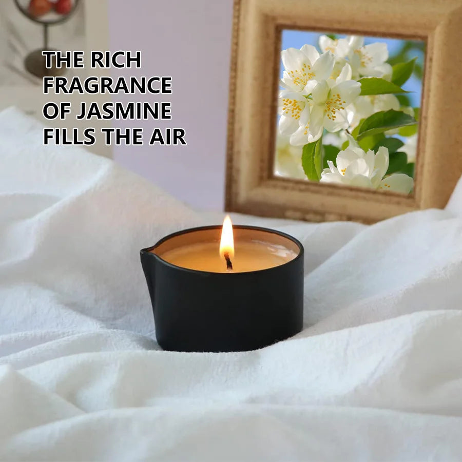 Candle with jasmine flowers in a mirror reflection on a white surface