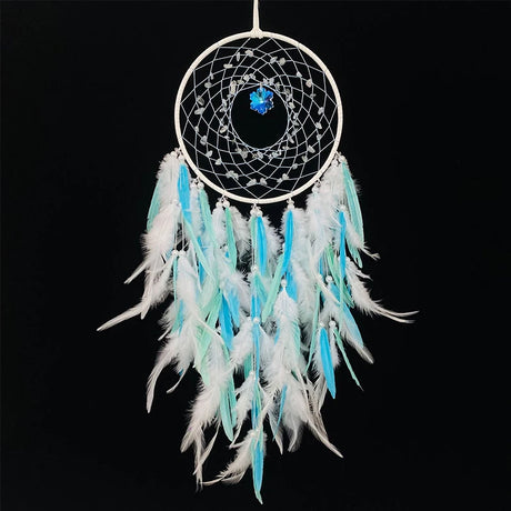 Dreamcatcher with white and blue feathers on a black background