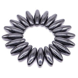 Circular arrangement of metallic beads on a white background