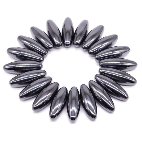 Circular arrangement of metallic beads on a white background